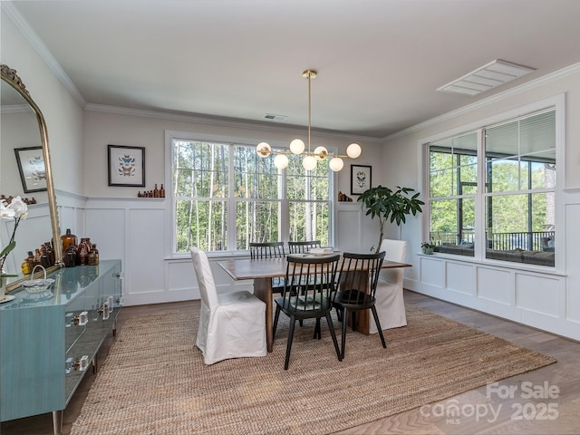143 Robinson Ridge Dr, Mooresville, NC 28117 - dining room featuring a chandelier, visible vents, crown molding, and wood finished floors