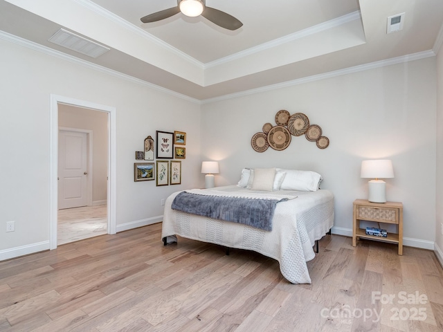 143 Robinson Ridge Dr, Mooresville, NC 28117 - bedroom featuring crown molding, visible vents, light wood-type flooring, and a tray ceiling