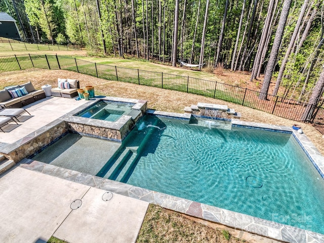 143 Robinson Ridge Dr, Mooresville, NC 28117 - view of pool featuring a patio area, a pool with connected hot tub, a lawn, a fenced backyard, and a view of trees
