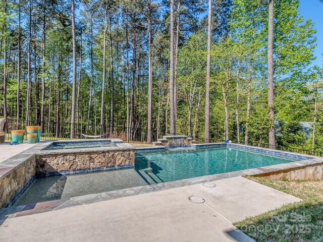 143 Robinson Ridge Dr, Mooresville, NC 28117 - outdoor pool with a patio area, an in ground hot tub, and a forest view