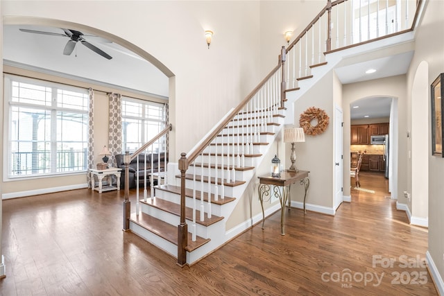 3005 Dream Catcher Cir, Fort Mill, SC 29715 - stairway featuring baseboards, arched walkways, ceiling fan, and wood finished floors