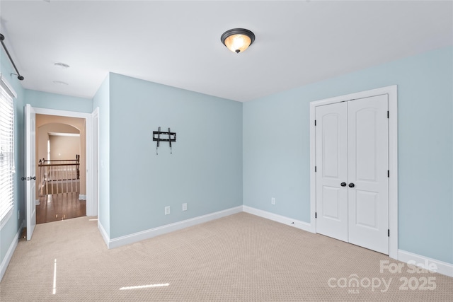 3005 Dream Catcher Cir, Fort Mill, SC 29715 - unfurnished bedroom featuring carpet floors, baseboards, a closet, and arched walkways