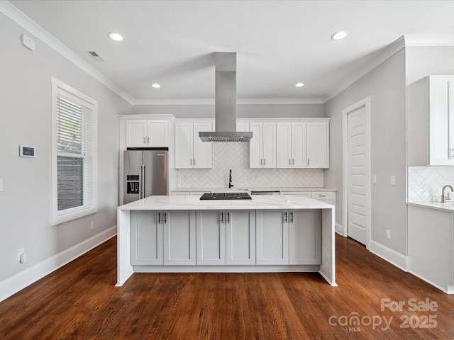 kitchen featuring backsplash, high quality fridge, white cabinetry, and a large island