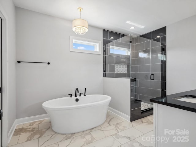 bathroom with a shower stall, a freestanding bath, marble finish floor, and baseboards