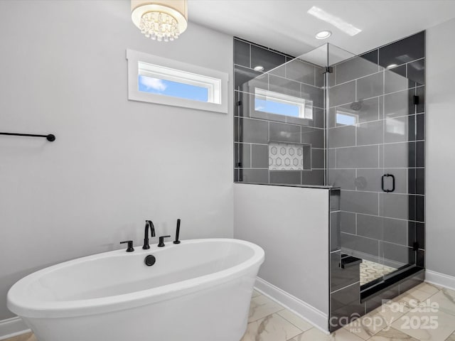 full bathroom featuring baseboards, a freestanding bath, a shower stall, recessed lighting, and marble finish floor