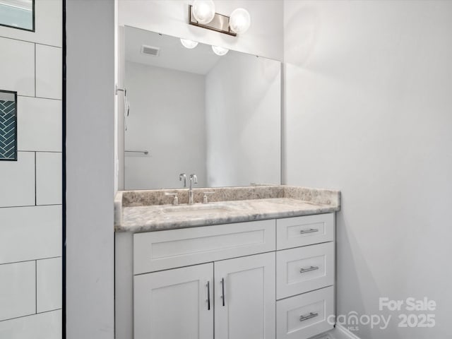 bathroom with visible vents and vanity