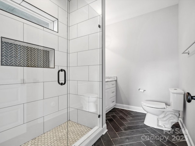 full bath with a shower stall, baseboards, and toilet