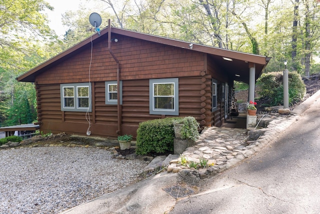 view of side of home with log siding