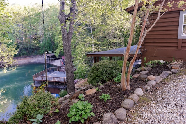 exterior space with a water view and a view of trees