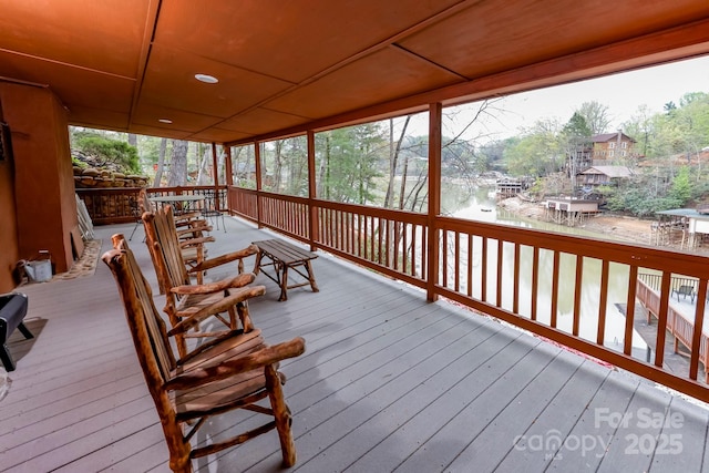wooden terrace featuring a water view