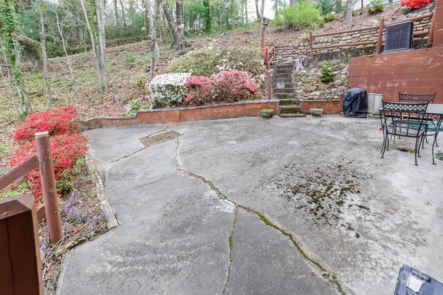 view of patio with area for grilling and fence