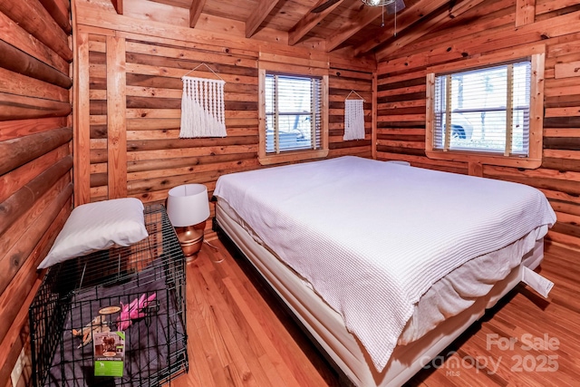 bedroom featuring wood finished floors, multiple windows, beamed ceiling, and wood ceiling