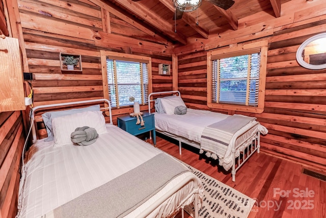 bedroom featuring wood finished floors, visible vents, wooden ceiling, and lofted ceiling with beams