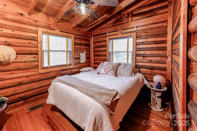 bedroom featuring vaulted ceiling with beams, visible vents, wooden ceiling, and wood finished floors