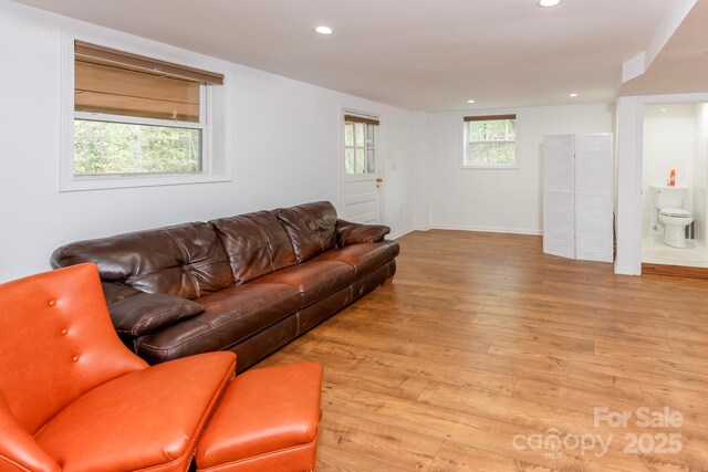 living area with recessed lighting, light wood finished floors, and baseboards