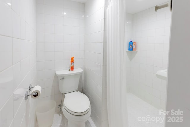 bathroom with toilet, tile walls, and tiled shower