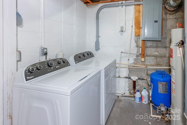 clothes washing area featuring electric panel, independent washer and dryer, laundry area, and concrete block wall