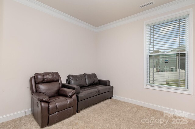 sitting room with carpet flooring, baseboards, ornamental molding, and visible vents
