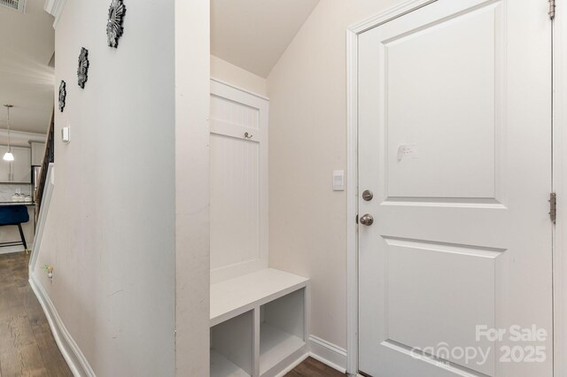 mudroom featuring baseboards and dark wood-style floors