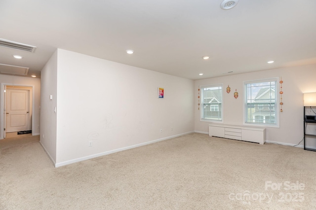 interior space featuring carpet floors, baseboards, attic access, and visible vents