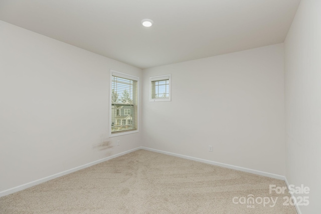carpeted empty room with baseboards