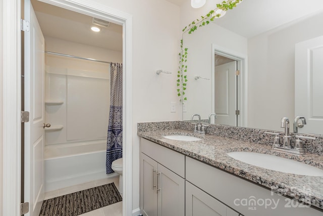 full bathroom with toilet, shower / bath combo, double vanity, and a sink