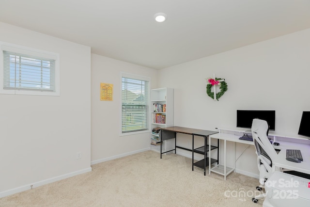 carpeted home office featuring baseboards