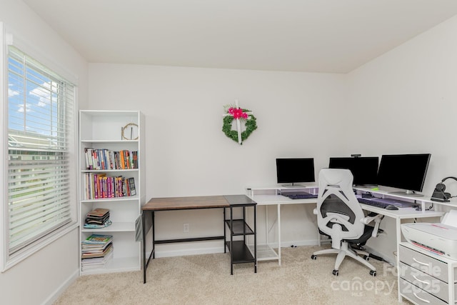 carpeted home office with baseboards