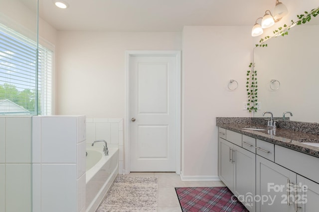 full bath with a bath, vanity, recessed lighting, tile patterned floors, and baseboards