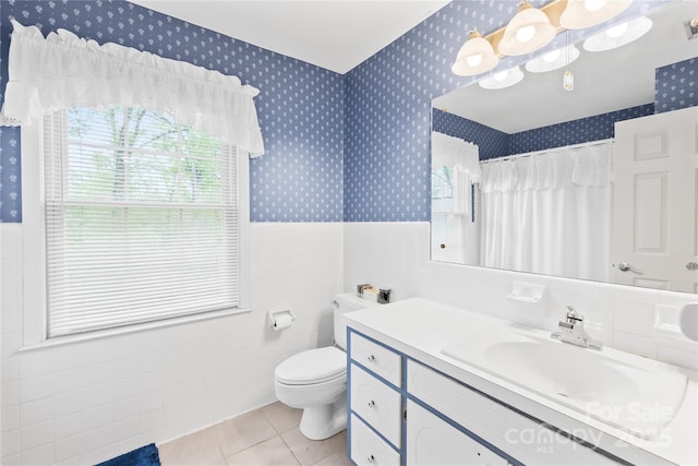 4896 Pageland Hwy, Lancaster, SC 29720 - full bath with wallpapered walls, vanity, a wainscoted wall, tile patterned floors, and plenty of natural light