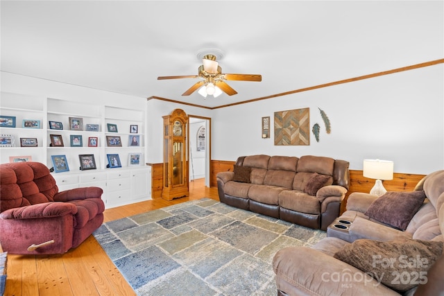 4896 Pageland Hwy, Lancaster, SC 29720 - living area featuring a ceiling fan, wood finished floors, a wainscoted wall, ornamental molding, and built in shelves