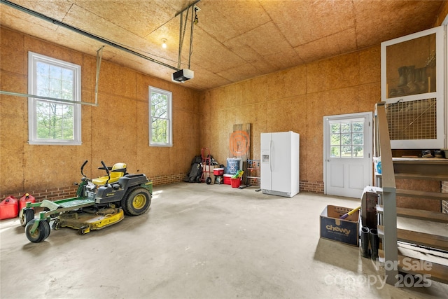 4896 Pageland Hwy, Lancaster, SC 29720 - garage with white refrigerator with ice dispenser and a garage door opener