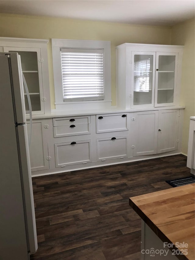 4896 Pageland Hwy, Lancaster, SC 29720 - kitchen featuring freestanding refrigerator, white cabinetry, dark wood-style floors, and glass insert cabinets