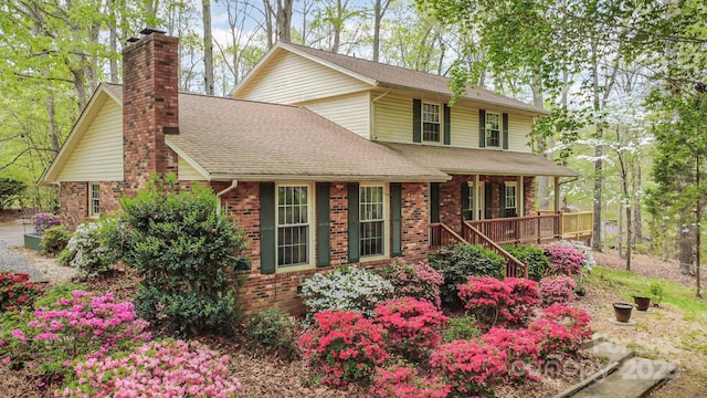147 Spring Shore Rd, Statesville, NC 28677 - view of front of property featuring brick siding, a chimney, a porch, and roof with shingles