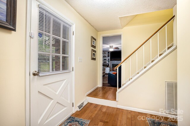 147 Spring Shore Rd, Statesville, NC 28677 - doorway with visible vents, stairway, wood finished floors, and a ceiling fan