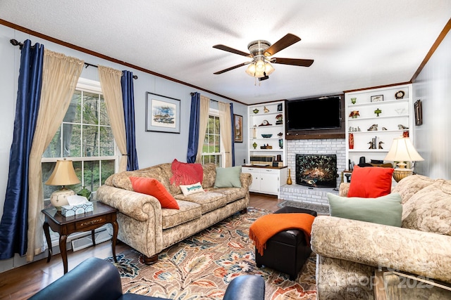 147 Spring Shore Rd, Statesville, NC 28677 - living area featuring a textured ceiling, crown molding, a brick fireplace, ceiling fan, and wood finished floors
