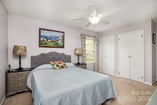 147 Spring Shore Rd, Statesville, NC 28677 - bedroom with light carpet, baseboards, two closets, and ceiling fan