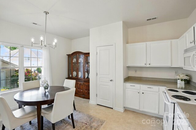 dining space with a notable chandelier and visible vents