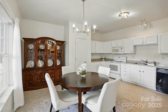 dining space with light floors and a notable chandelier