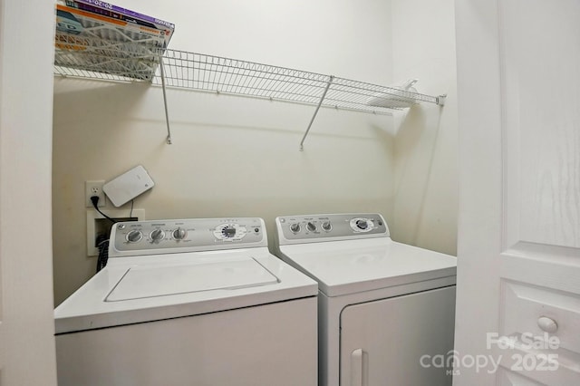 laundry area with laundry area and washer and clothes dryer