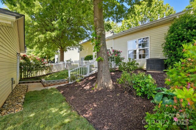 view of yard featuring fence and cooling unit