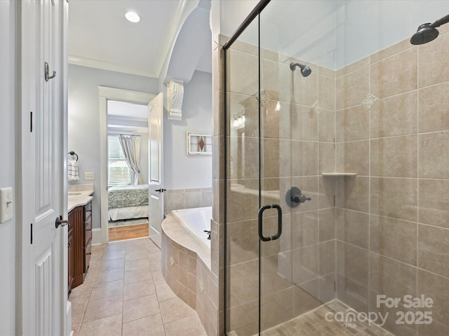 bathroom featuring a stall shower, a bath, ensuite bathroom, tile patterned flooring, and vanity