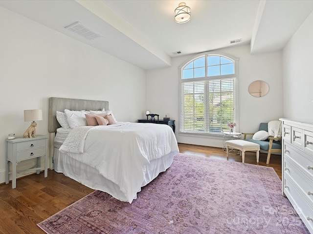 bedroom with dark wood-type flooring and visible vents