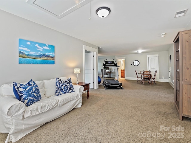 carpeted living room with baseboards and visible vents