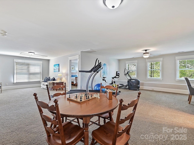 dining area featuring carpet, baseboards, and ceiling fan