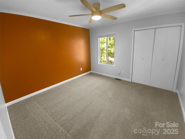 8000 Briardale Dr, Charlotte, NC 28212 - unfurnished bedroom featuring a closet, ceiling fan, baseboards, and carpet floors
