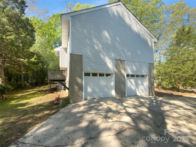 8000 Briardale Dr, Charlotte, NC 28212 - view of side of property featuring driveway, central AC, and an attached garage