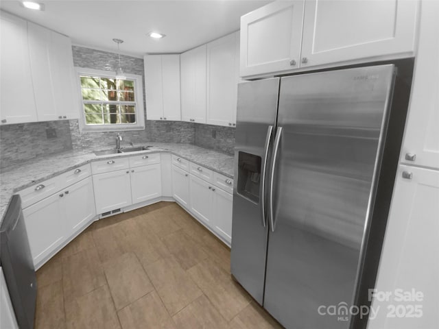 8000 Briardale Dr, Charlotte, NC 28212 - kitchen with stainless steel fridge with ice dispenser, white cabinets, decorative backsplash, and a sink