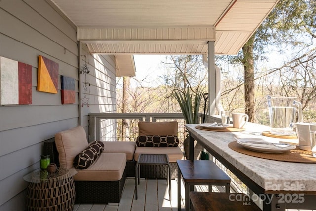 view of wooden balcony featuring outdoor lounge area and a wooden deck