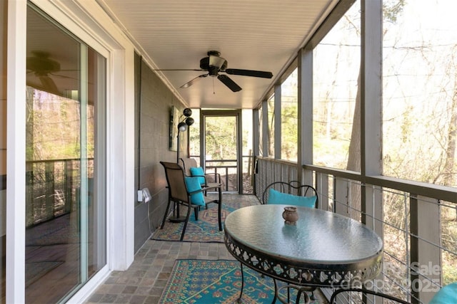 sunroom featuring a ceiling fan